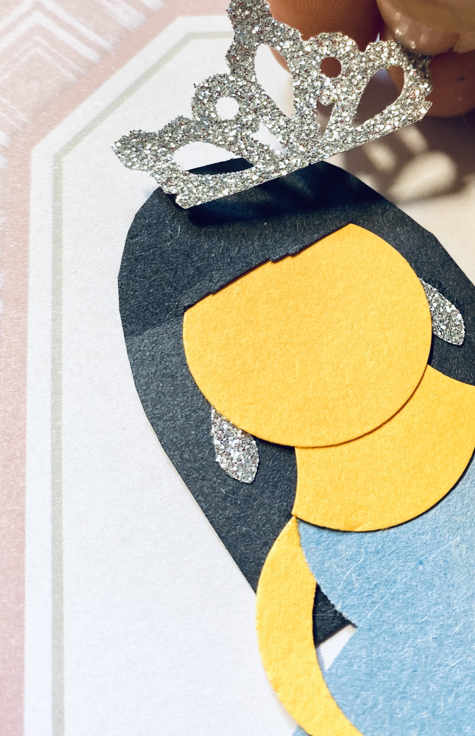 Here we are adding a glittery silver crown to the paper princess.  She also has her glittery earrings on.
