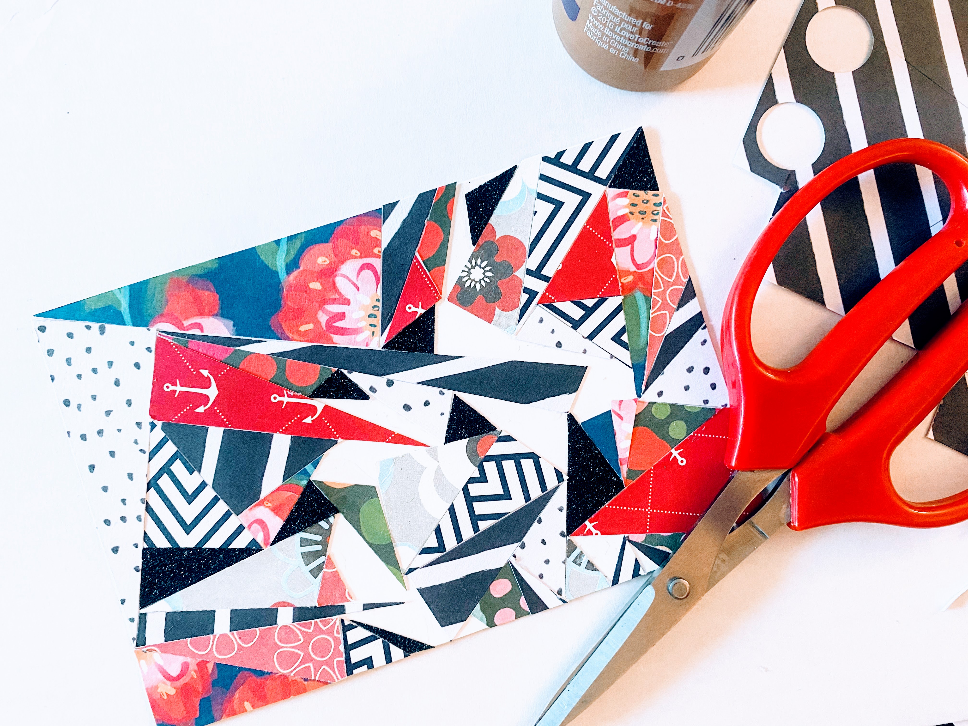 Here we tried to fill in the gaps by cutting smaller triangles to fit in between larger triangles of our abstract art card.