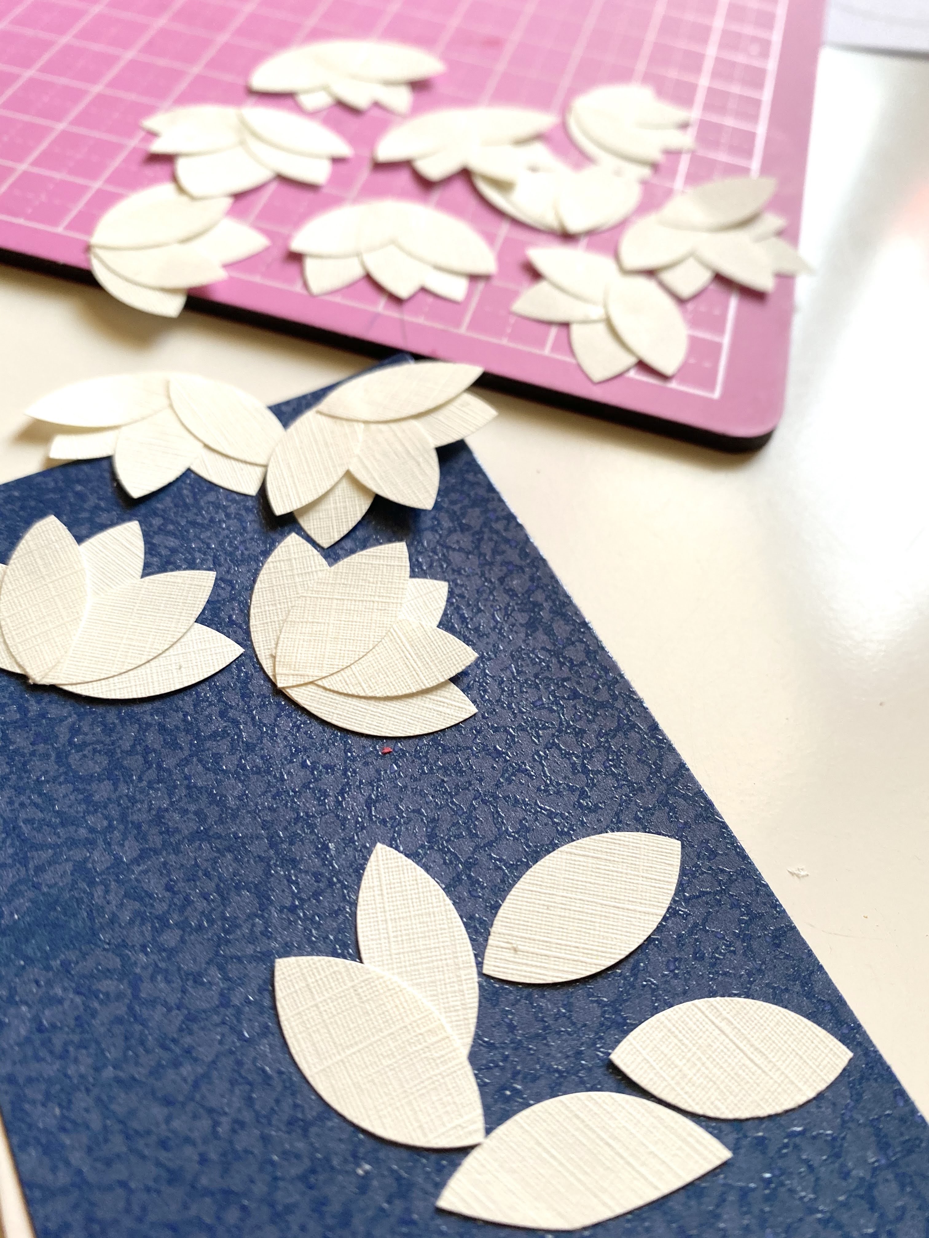 Making magnolia flowers out of textured resume paper for a homemade card.