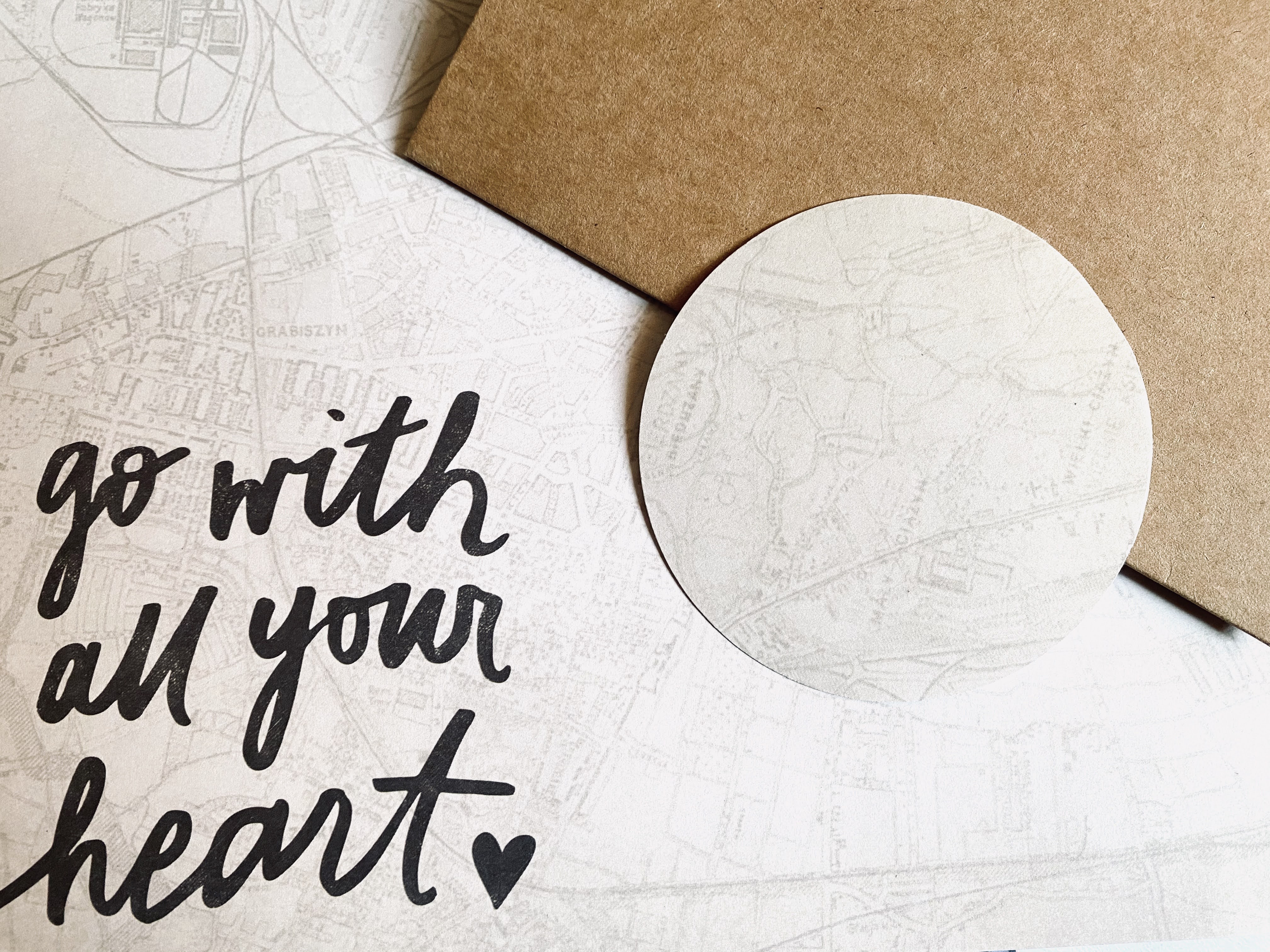 How to make an interesting full moon by cutting out a circle from scrapbook paper with the image of a map route or transportation route.