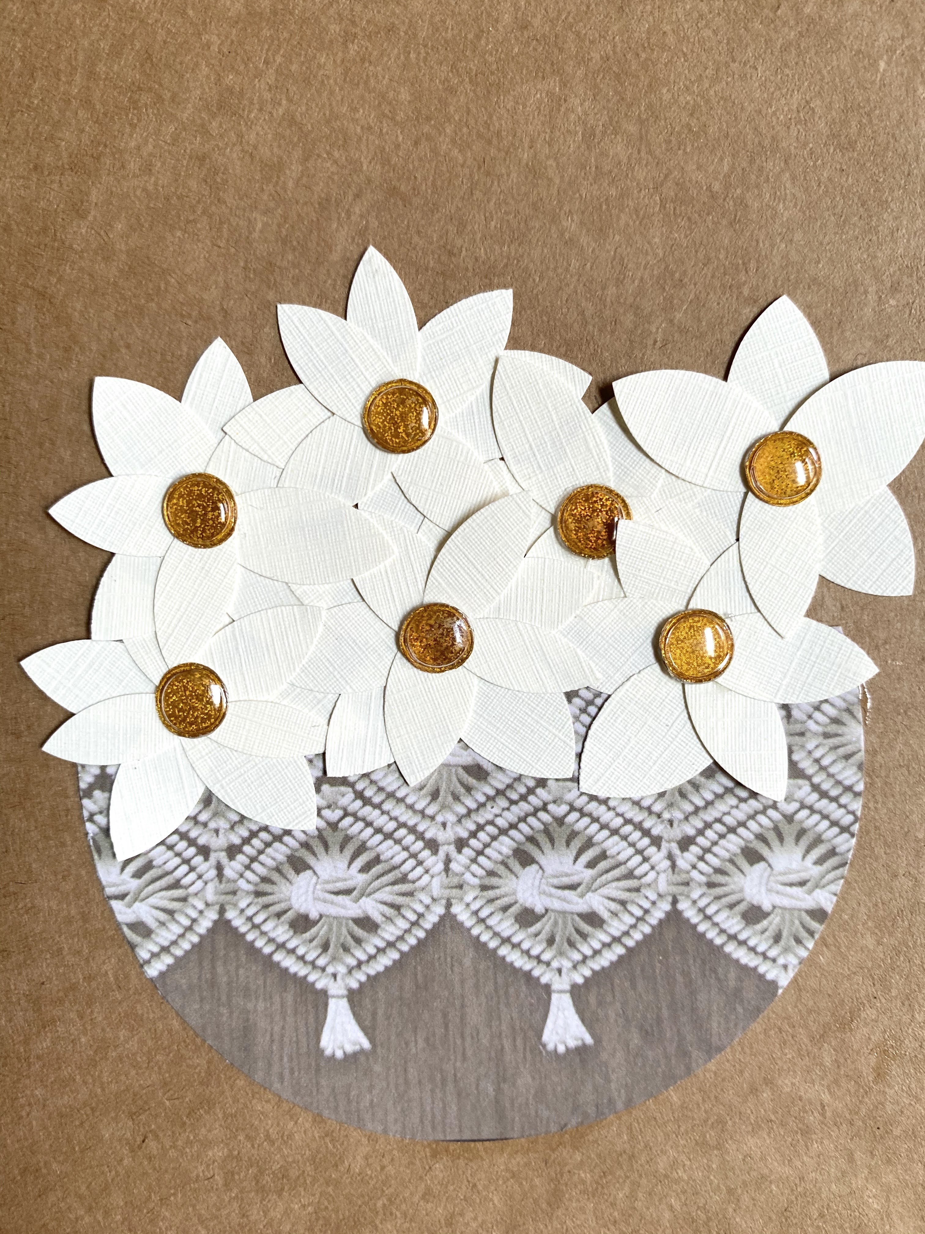 A homemade card made of scrapbook paper and resume paper to form a group of magnolias in a flower basket.  A simple and earthy homemade card.